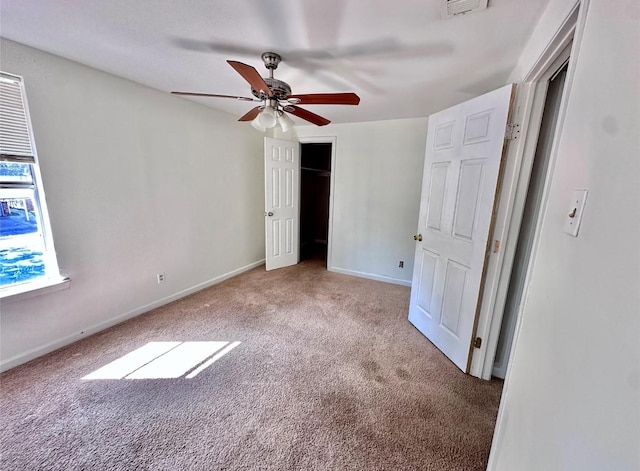 unfurnished bedroom with ceiling fan and carpet