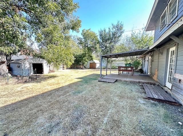 view of yard with a storage shed and a patio