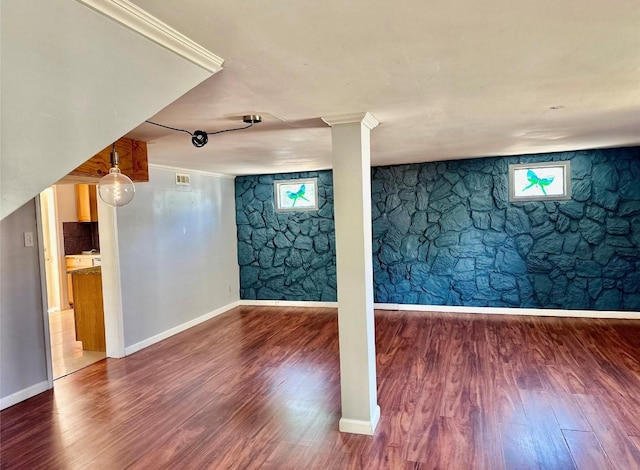 basement featuring wood-type flooring and crown molding