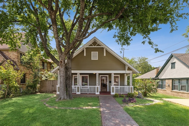 bungalow featuring a front yard and covered porch