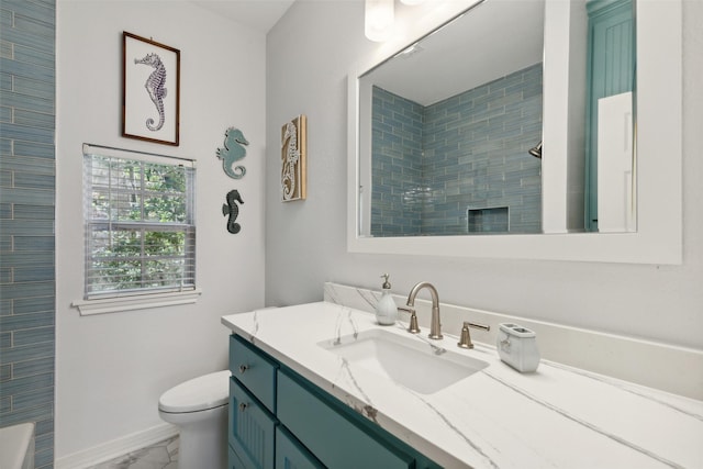 bathroom with toilet, a shower, and vanity