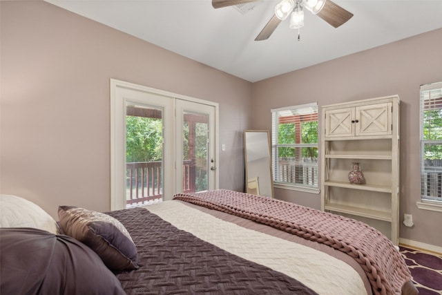 bedroom featuring multiple windows, ceiling fan, and access to outside