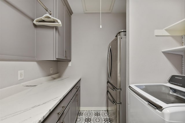 laundry room featuring cabinets