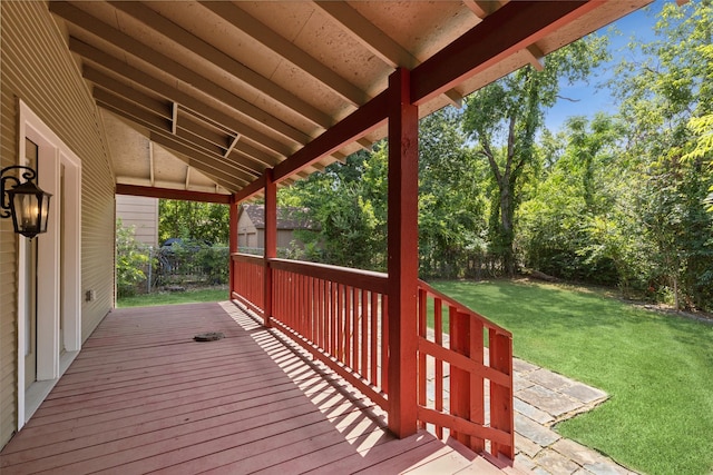 wooden deck featuring a lawn