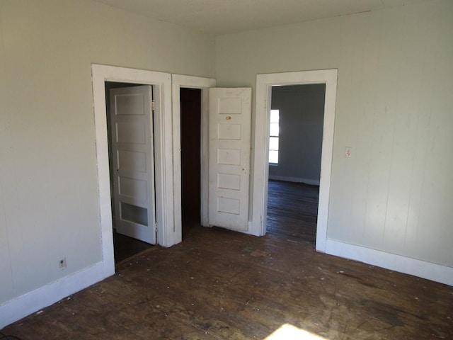 unfurnished bedroom featuring dark hardwood / wood-style flooring