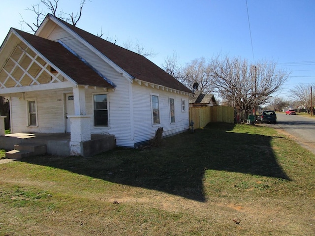 view of side of home with a lawn