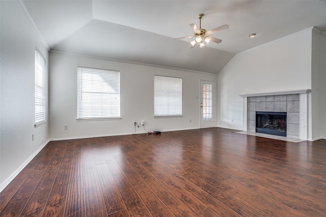 unfurnished living room featuring ceiling fan, ornamental molding, dark hardwood / wood-style floors, a fireplace, and lofted ceiling