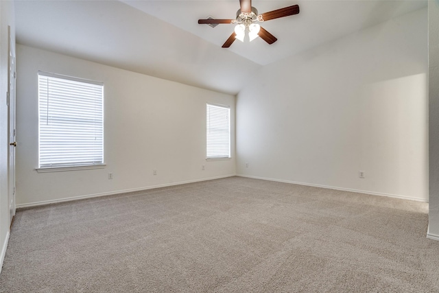 spare room featuring ceiling fan, light carpet, and a healthy amount of sunlight