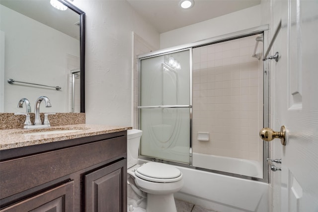 full bathroom with toilet, combined bath / shower with glass door, tile patterned floors, and vanity