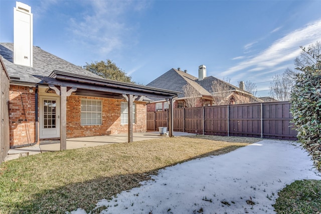 exterior space featuring a lawn and a patio area