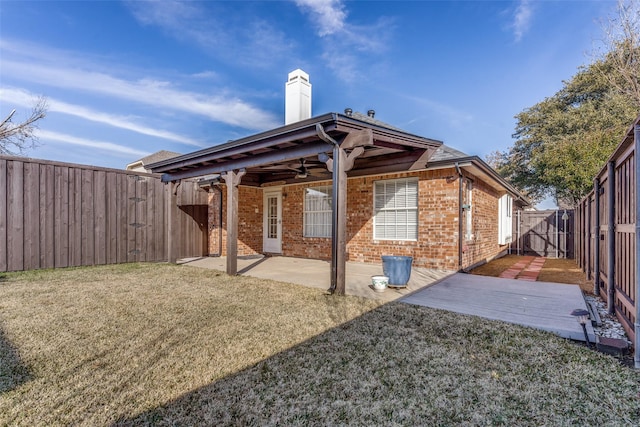 rear view of property with a patio and a yard