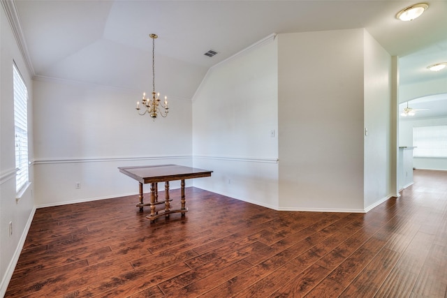 dining area featuring ceiling fan with notable chandelier, vaulted ceiling, plenty of natural light, and dark wood-type flooring