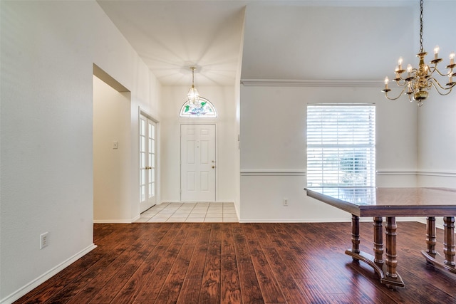 foyer featuring french doors, hardwood / wood-style floors, and a notable chandelier