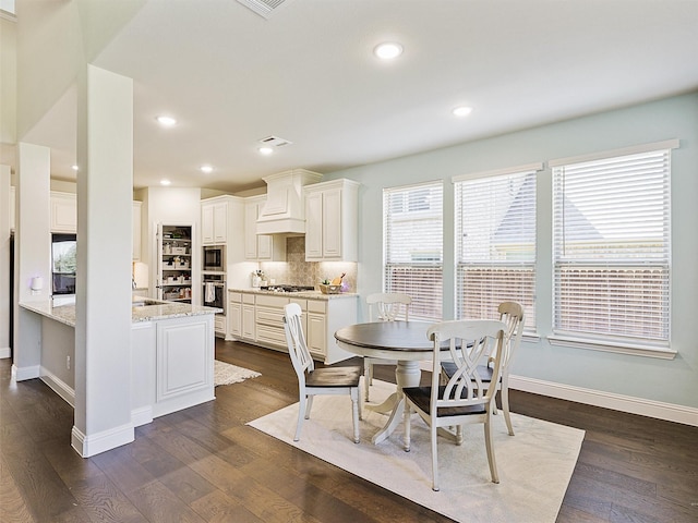 dining space with sink and dark hardwood / wood-style floors