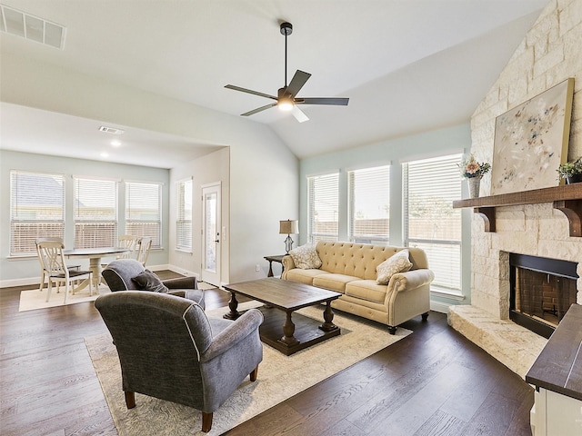 living room with lofted ceiling, a fireplace, ceiling fan, and a healthy amount of sunlight