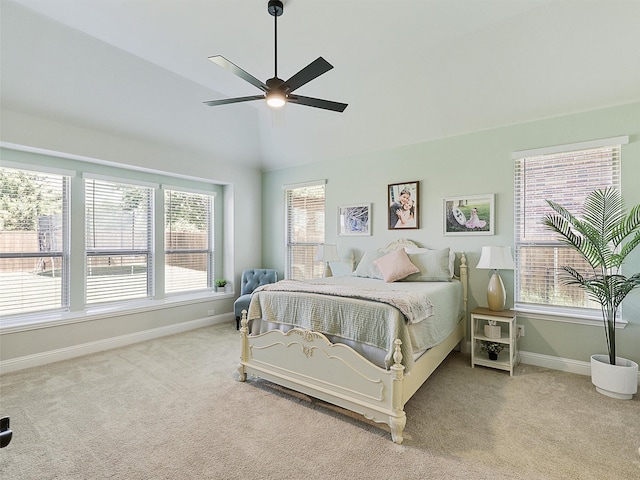 carpeted bedroom featuring lofted ceiling and ceiling fan