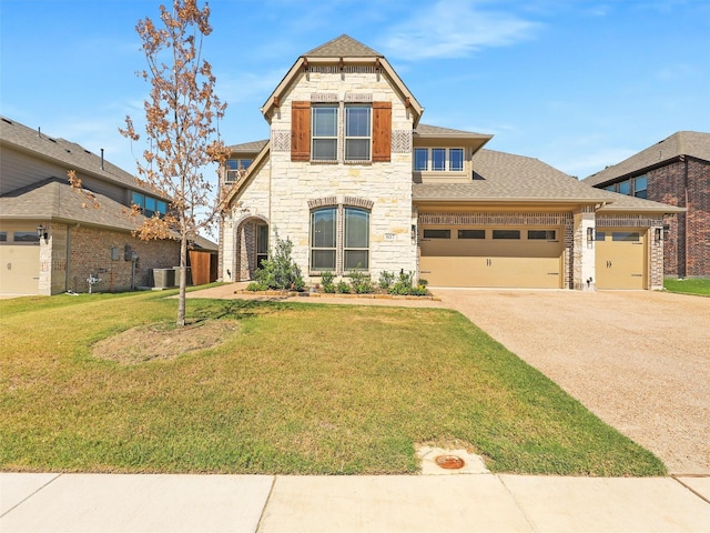 view of front of home featuring a front yard, a garage, and central air condition unit