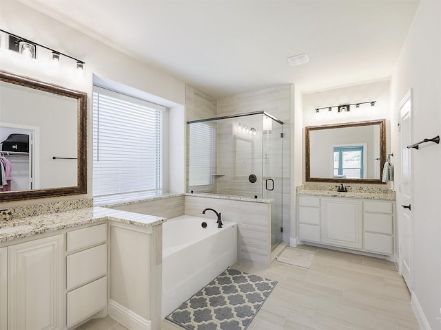 bathroom featuring independent shower and bath, tile patterned floors, and vanity