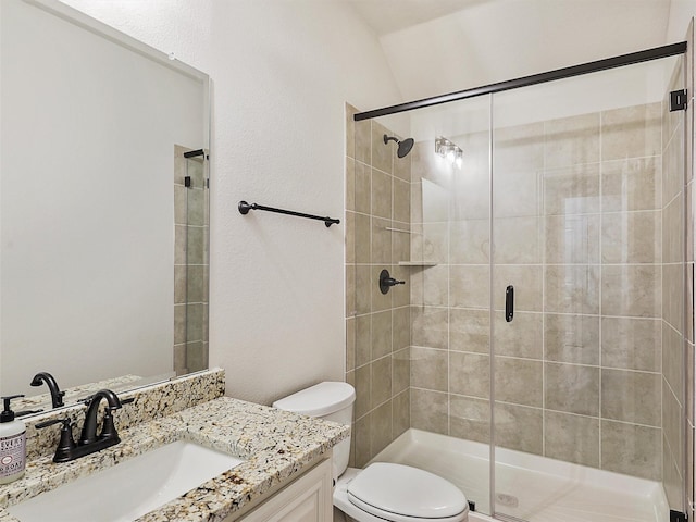 bathroom with toilet, an enclosed shower, and vanity