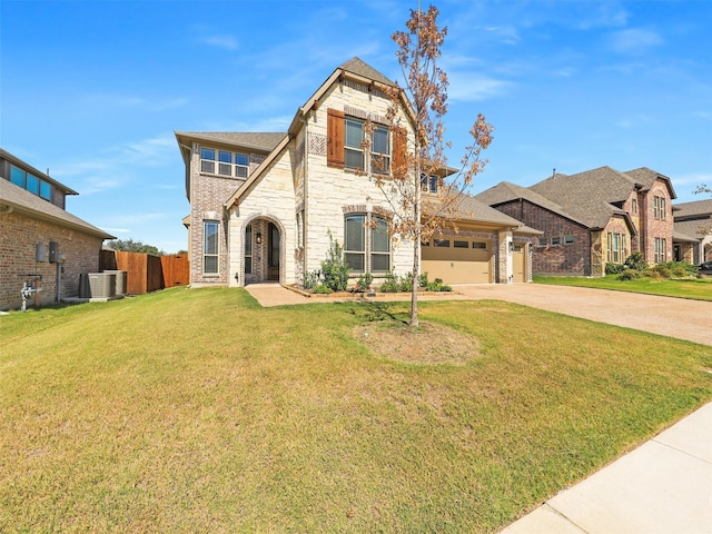 view of front of property featuring central AC unit, a front lawn, and a garage