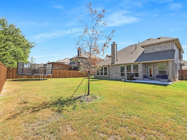 view of yard with a patio area and a trampoline