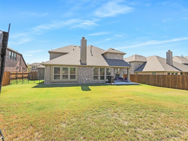 back of house featuring a patio and a yard