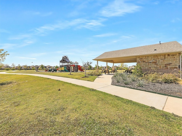 view of community featuring a playground and a lawn