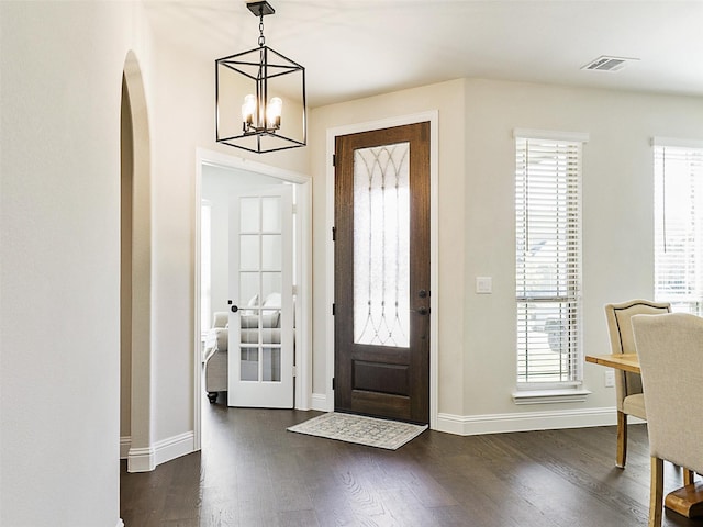 entrance foyer with french doors, a chandelier, and dark hardwood / wood-style flooring