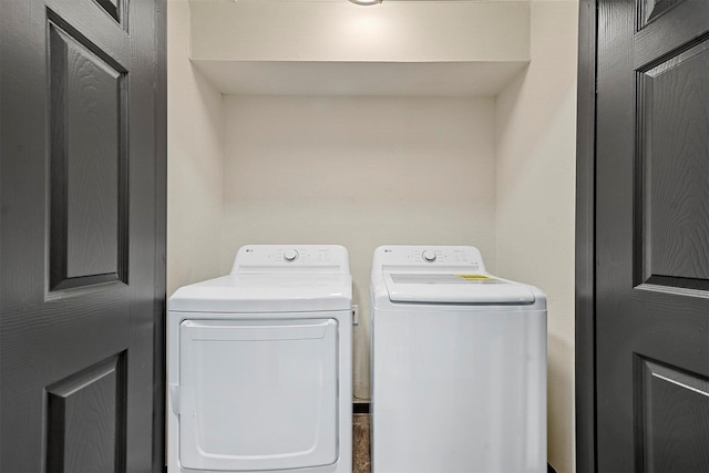 clothes washing area with washing machine and clothes dryer