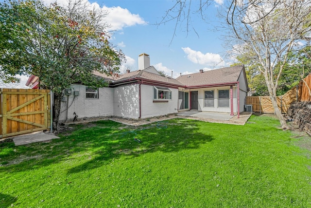 back of property featuring a lawn, a patio area, and central air condition unit