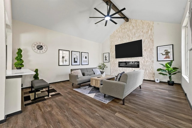 living room with a stone fireplace, ceiling fan, dark hardwood / wood-style flooring, high vaulted ceiling, and beam ceiling