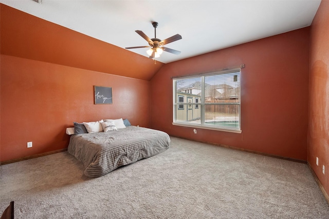 carpeted bedroom with lofted ceiling, ceiling fan, and baseboards