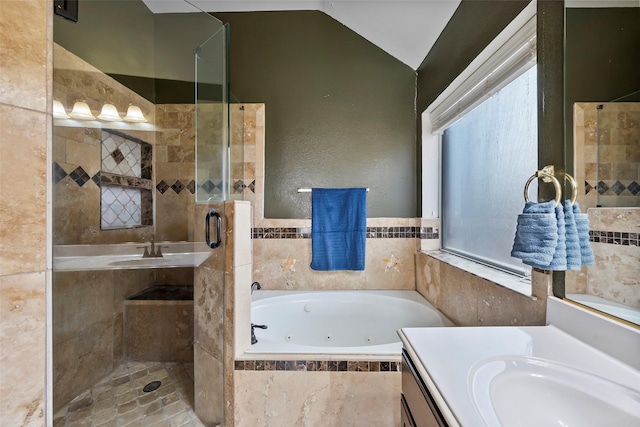 full bathroom with a stall shower, a tub with jets, vaulted ceiling, and vanity