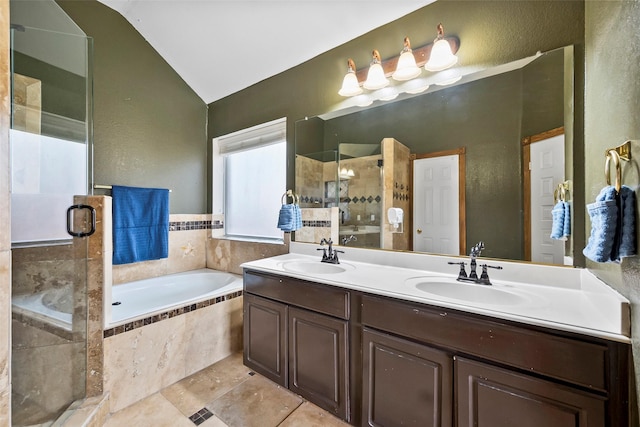 bathroom featuring tile patterned flooring, shower with separate bathtub, vanity, and vaulted ceiling