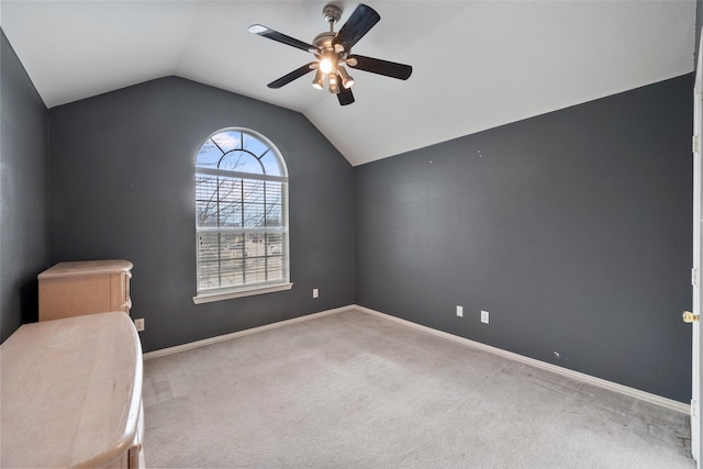 unfurnished bedroom with ceiling fan, light colored carpet, and lofted ceiling