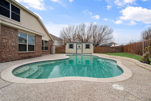 view of pool with a fenced in pool, an outbuilding, a fenced backyard, and a patio