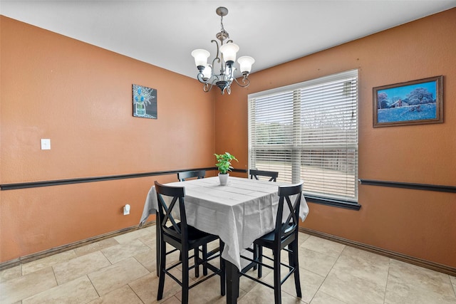 tiled dining space with a chandelier