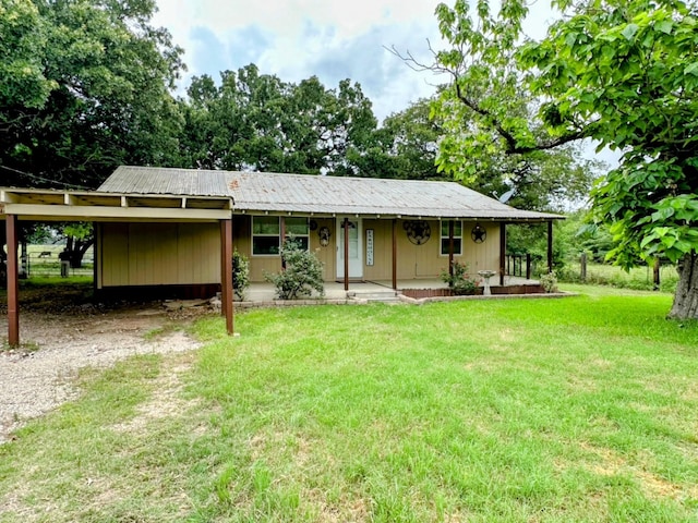 ranch-style home featuring a porch, a front lawn, and a carport