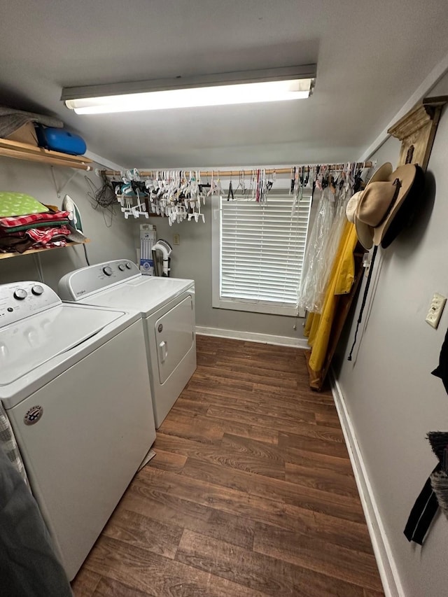 laundry area with dark hardwood / wood-style floors and washing machine and clothes dryer