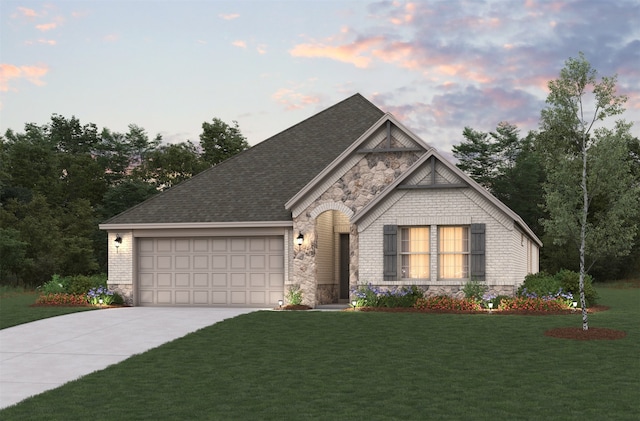 view of front facade with a yard and a garage