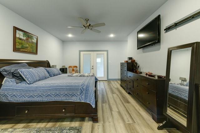 bedroom with recessed lighting, french doors, ceiling fan, and light wood-style flooring