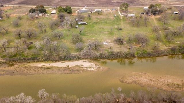 birds eye view of property featuring a rural view and a water view