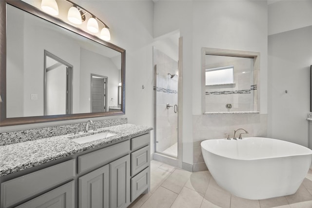 bathroom featuring vanity, tile patterned floors, and separate shower and tub