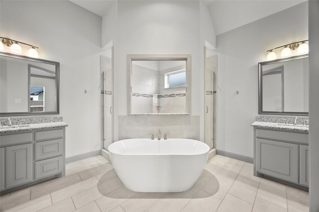 bathroom featuring vanity, tile patterned floors, and plus walk in shower