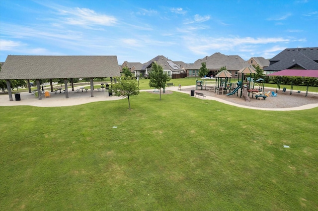 view of community with a playground, a gazebo, and a lawn