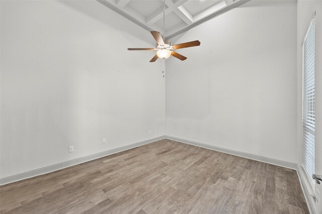 living area with a raised ceiling, a notable chandelier, and hardwood / wood-style floors