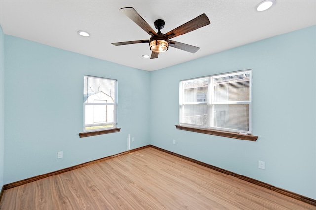 unfurnished room featuring light hardwood / wood-style floors and ceiling fan