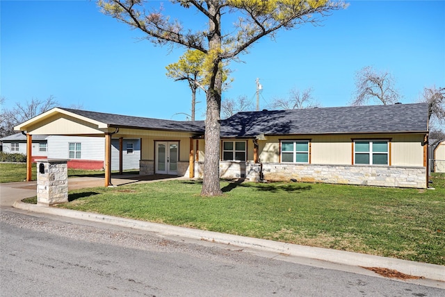 ranch-style home featuring french doors and a front lawn