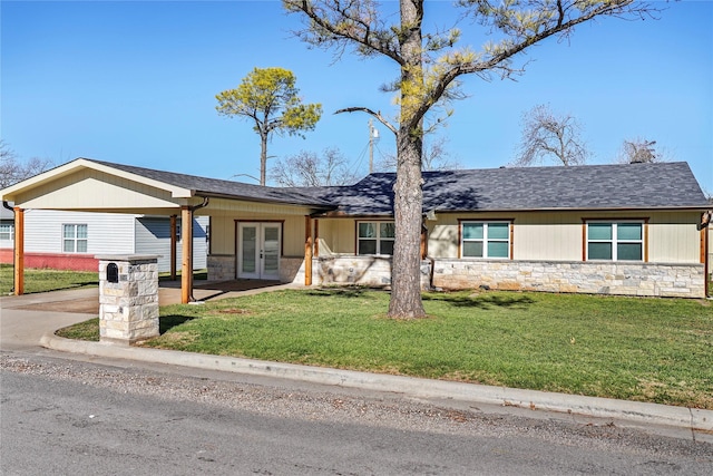 ranch-style home with a front yard and french doors