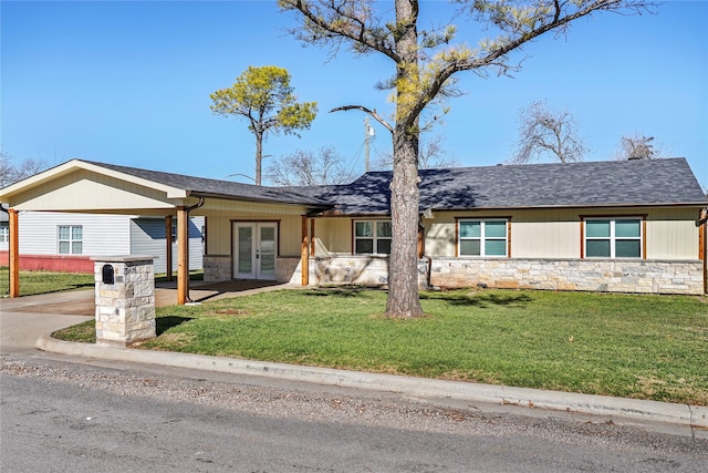 ranch-style home featuring a front yard and french doors